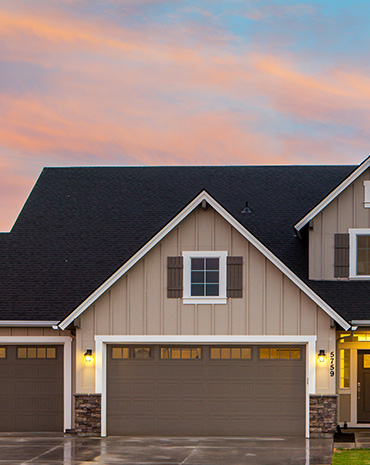 House with a dark roof and garage