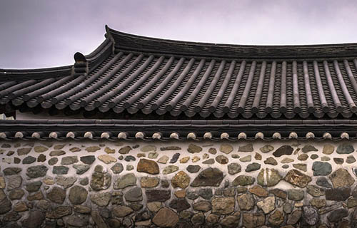 Tile roof over a stone wall
