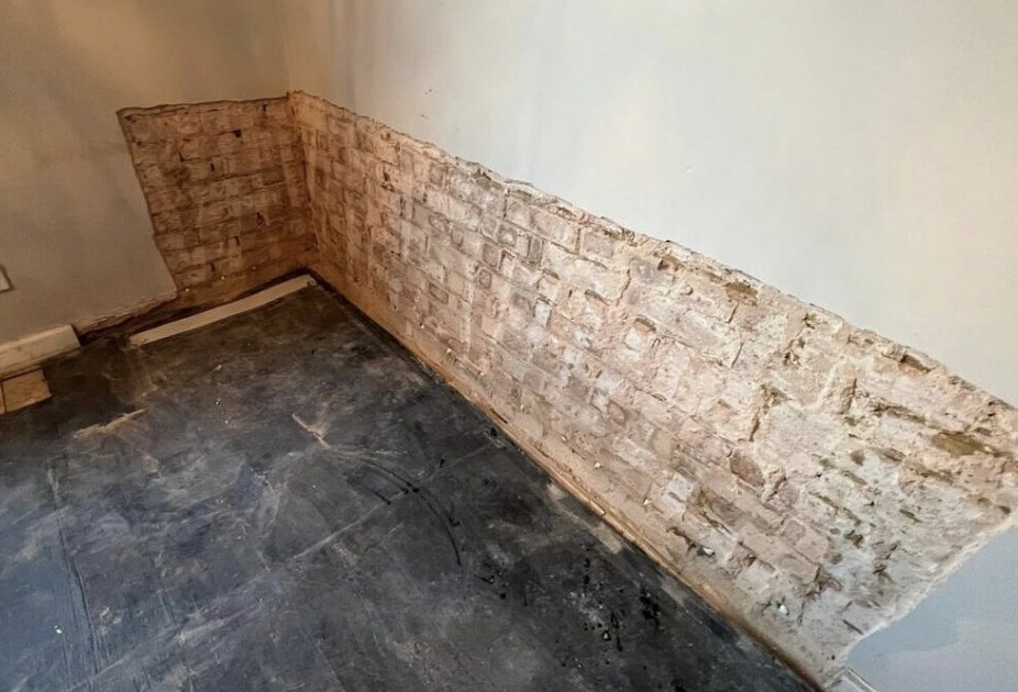 Exposed brick basement wall stripped back during renovation
