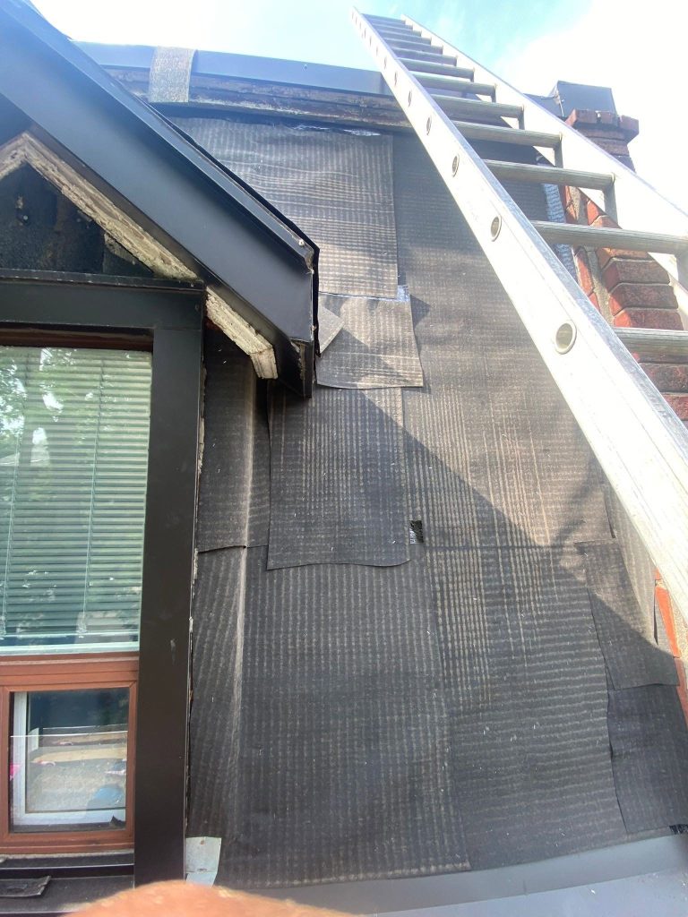 Roof underlayment and flashing installed around a dormer window