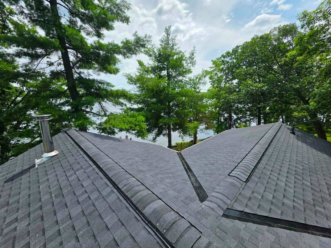 Dark shingle roof with valleys and ridge vents