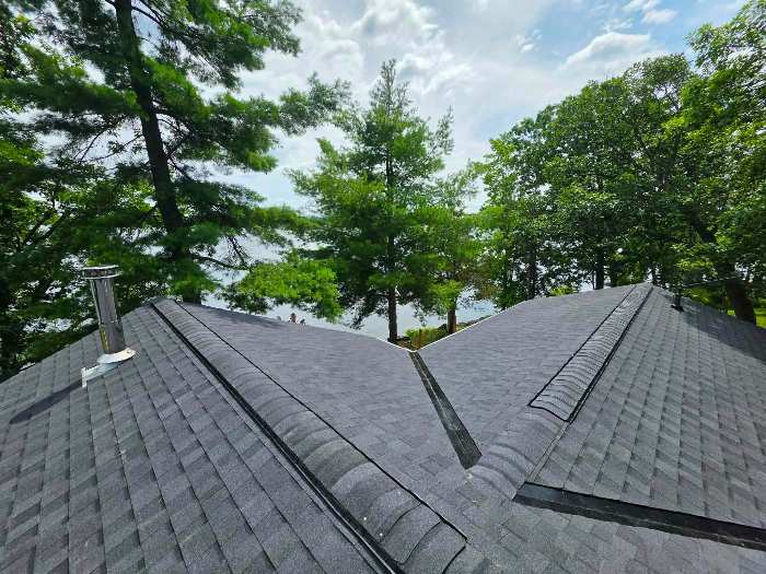 Dark shingle roof with valleys and ridge vents