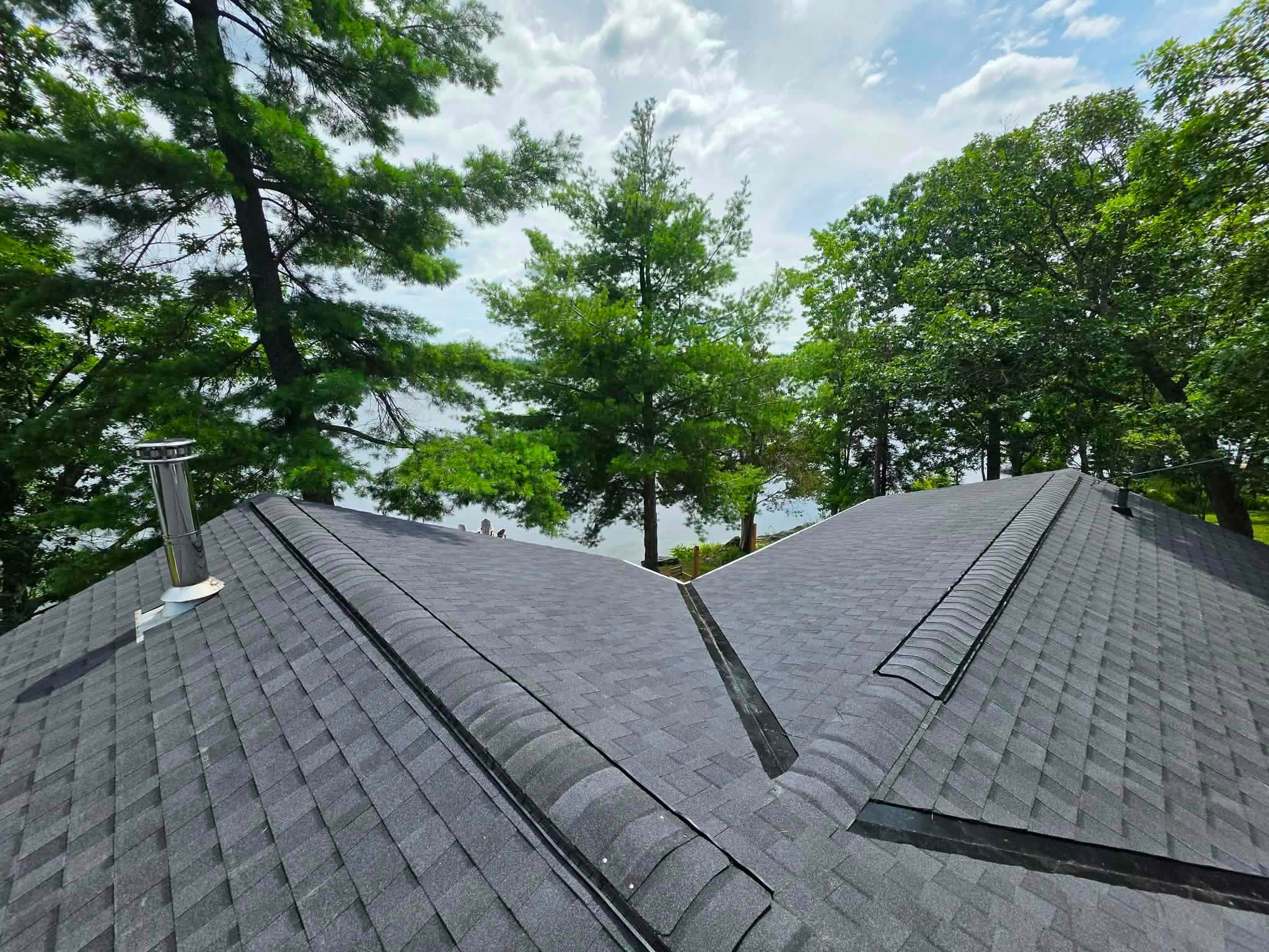 Dark shingle roof with valleys and ridge vents