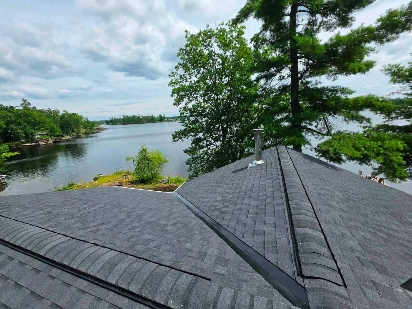 Dark shingle roof with roof vent pipe