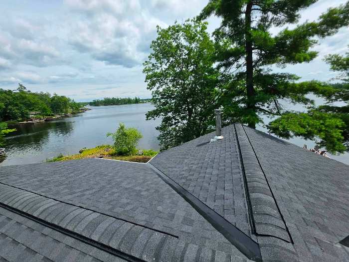Dark shingle roof with roof vent pipe
