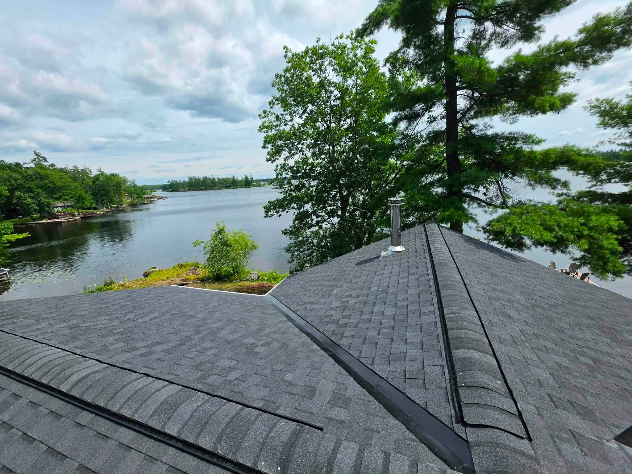 Dark shingle roof with roof vent pipe